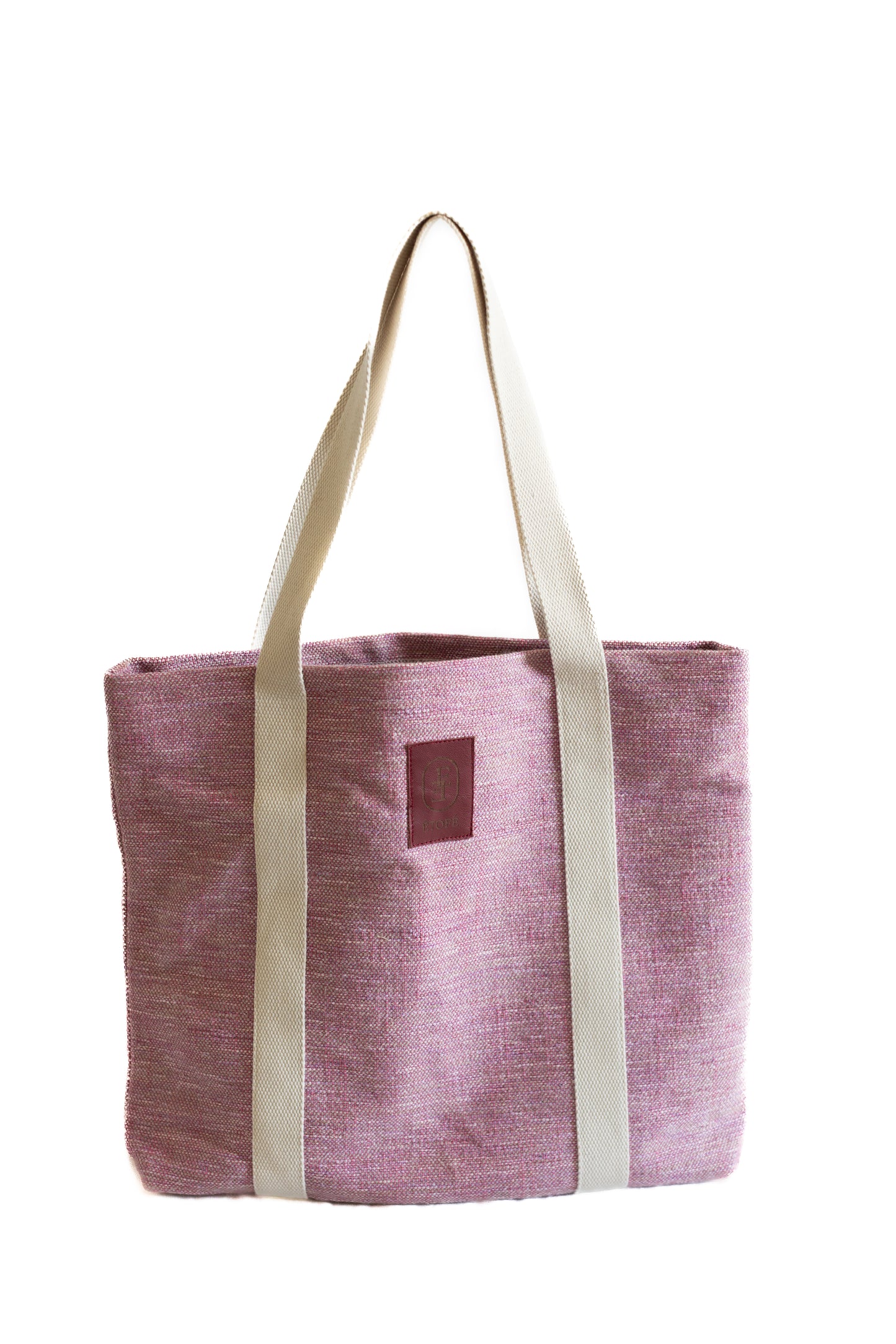 Sac tote bag ÉTOFÉ en tissu rose upcyclé vu de face, avec longues anses en coton écru, style minimaliste, fond blanc.